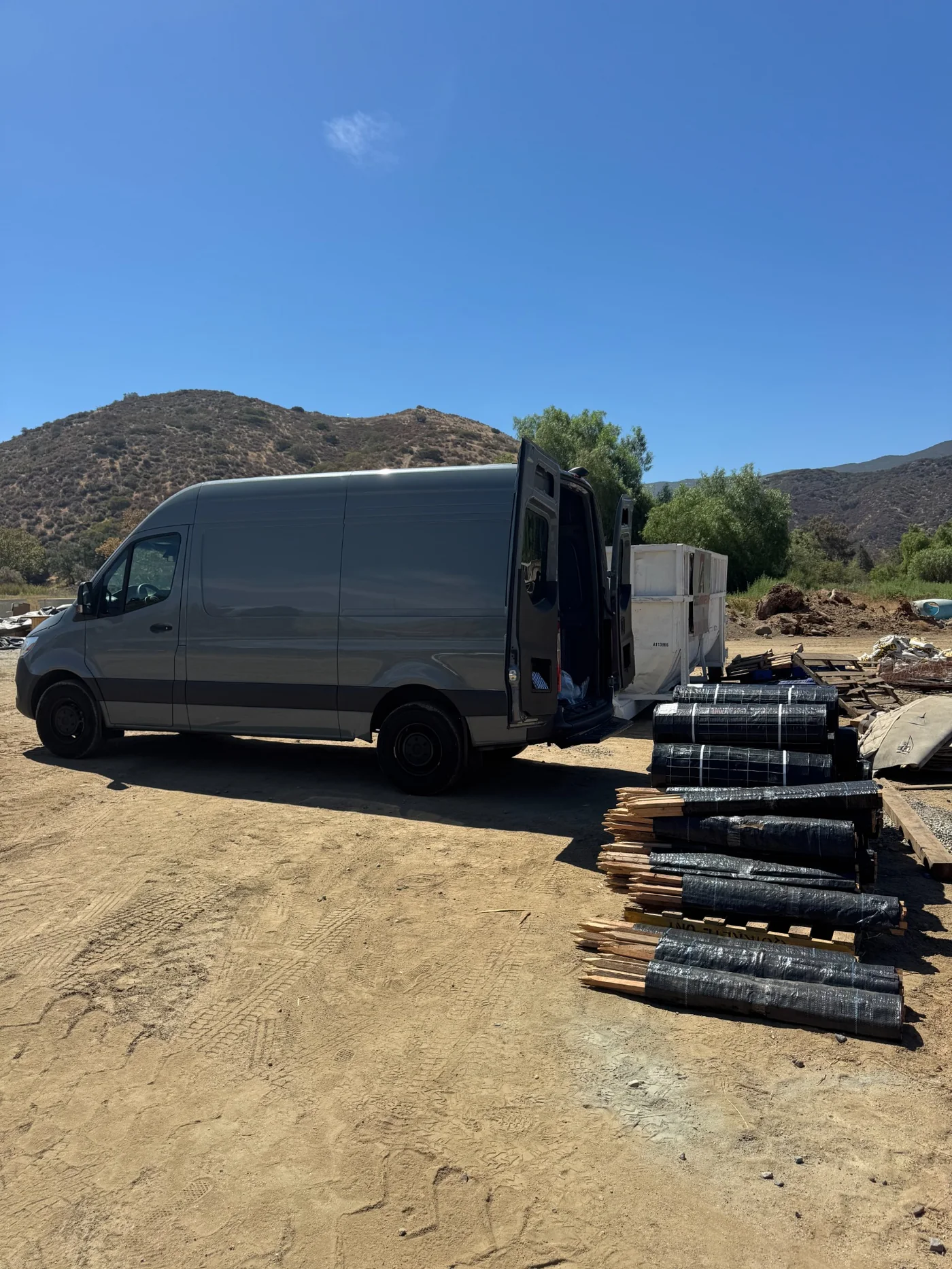 Cargo van delivering construction materials at a jobsite
